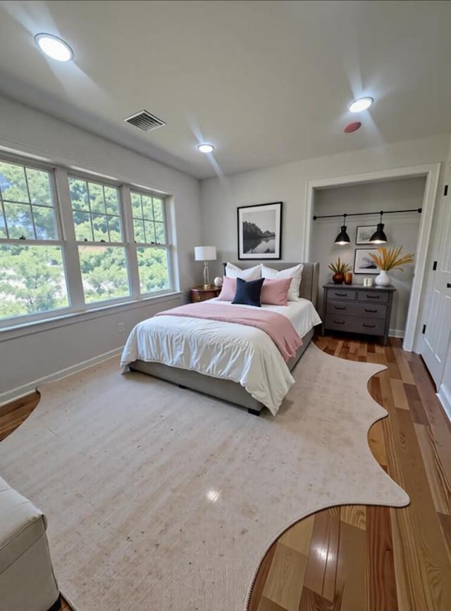 139 Miller Ave SW, Amityville, NY 11701 - bedroom with baseboards, wood finished floors, and recessed lighting