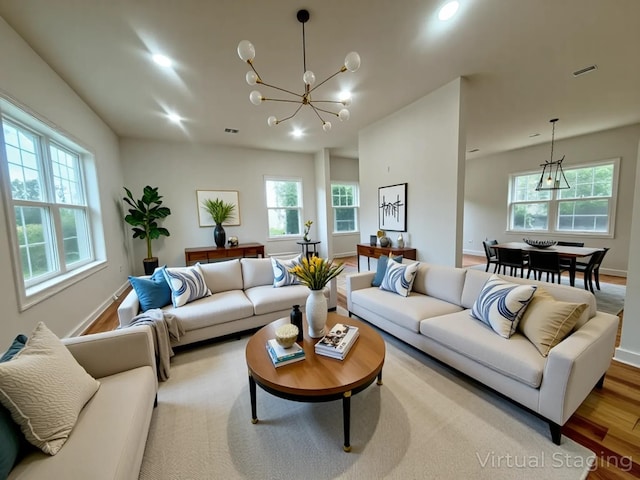 139 Miller Ave SW, Amityville, NY 11701 - living room with plenty of natural light, a chandelier, wood finished floors, recessed lighting, and baseboards