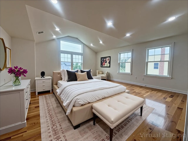 139 Miller Ave SW, Amityville, NY 11701 - bedroom with light wood-style flooring, multiple windows, vaulted ceiling, and baseboards