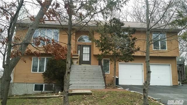 15 Oakhurst St, Huntington Station, NY 11746 - view of front of home featuring a garage and asphalt driveway