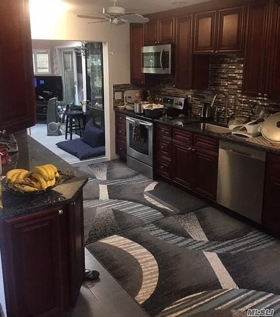15 Oakhurst St, Huntington Station, NY 11746 - kitchen featuring appliances with stainless steel finishes, a sink, dark countertops, and a ceiling fan