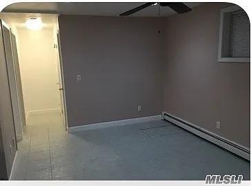15 Oakhurst St, Huntington Station, NY 11746 - spare room with a ceiling fan, baseboards, and baseboard heating