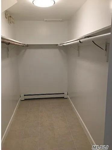 15 Oakhurst St, Huntington Station, NY 11746 - spacious closet featuring baseboard heating