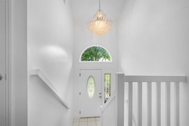 15 Oakhurst St, Huntington Station, NY 11746 - entrance foyer featuring a chandelier, light tile patterned flooring, and a towering ceiling