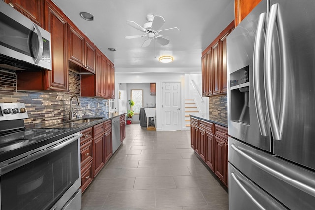 15 Oakhurst St, Huntington Station, NY 11746 - kitchen featuring stainless steel appliances, a ceiling fan, backsplash, dark stone countertops, and dark tile patterned flooring
