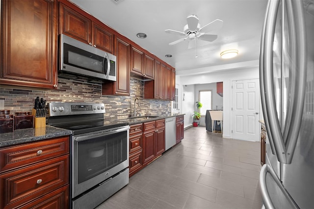 15 Oakhurst St, Huntington Station, NY 11746 - kitchen featuring stainless steel appliances, decorative backsplash, a ceiling fan, dark stone countertops, and tile patterned flooring