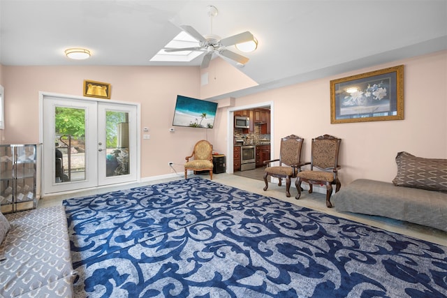 15 Oakhurst St, Huntington Station, NY 11746 - living area featuring lofted ceiling, a skylight, ceiling fan, french doors, and carpet