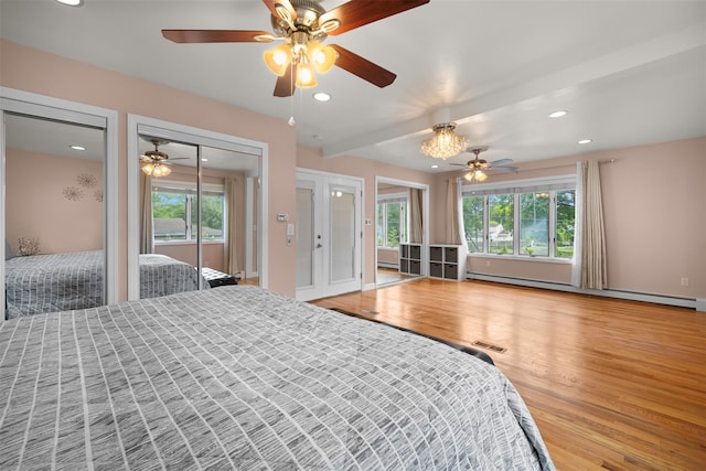 15 Oakhurst St, Huntington Station, NY 11746 - bedroom with wood finished floors, recessed lighting, baseboard heating, multiple windows, and ceiling fan
