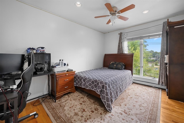 15 Oakhurst St, Huntington Station, NY 11746 - bedroom with an office area, light wood-type flooring, recessed lighting, a baseboard heating unit, and ceiling fan