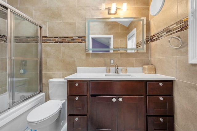 15 Oakhurst St, Huntington Station, NY 11746 - full bathroom with tile walls, vanity, shower / bath combination with glass door, and backsplash