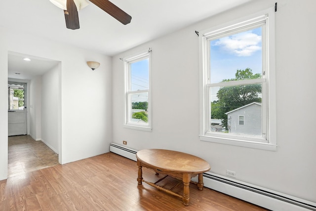 53 Howard St, Mount Vernon, NY 10550 - sitting room with baseboard heating, ceiling fan, and light wood-style floors
