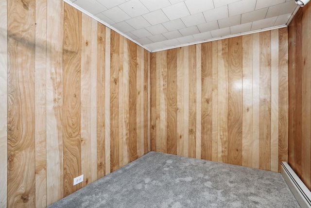 53 Howard St, Mount Vernon, NY 10550 - empty room with a baseboard radiator, wooden walls, and carpet floors