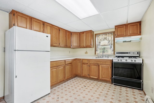 53 Howard St, Mount Vernon, NY 10550 - kitchen with freestanding refrigerator, range with gas stovetop, under cabinet range hood, a paneled ceiling, and a sink