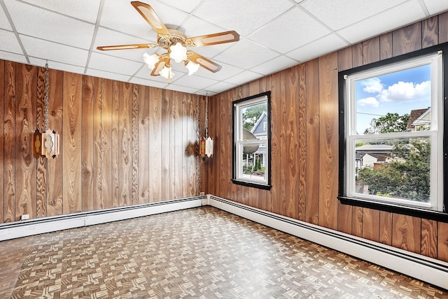 53 Howard St, Mount Vernon, NY 10550 - spare room with wood walls, a paneled ceiling, ceiling fan, and baseboard heating