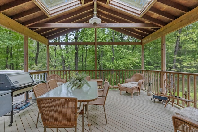 deck featuring a wooded view and outdoor dining area