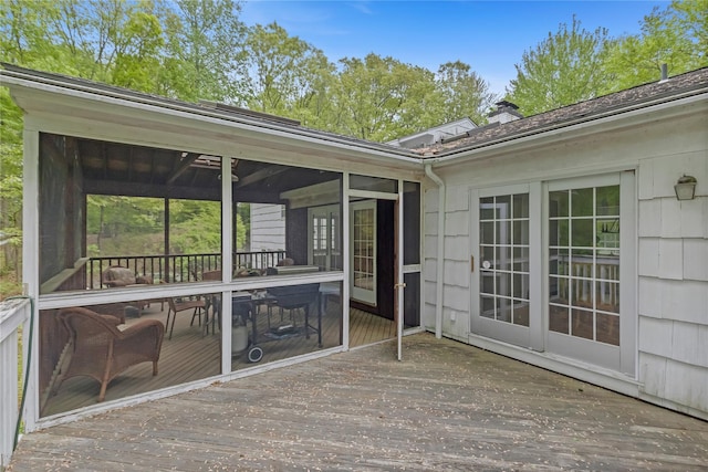 wooden deck featuring a sunroom