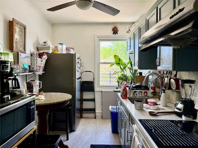 69-11 58th Rd, Maspeth, NY 11378 - kitchen with stainless steel appliances, under cabinet range hood, a ceiling fan, crown molding, and light countertops