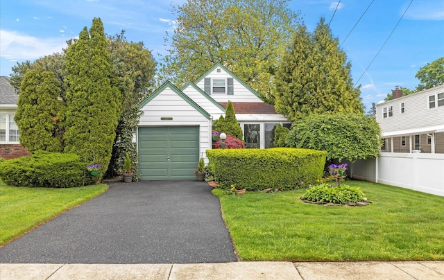 164 New York Ave, West Hempstead, NY 11552 - view of front of house with asphalt driveway, an attached garage, brick siding, and an outbuilding