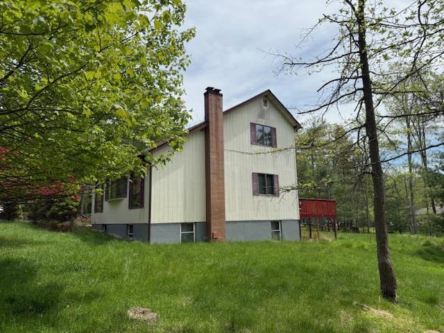 view of property exterior with a chimney
