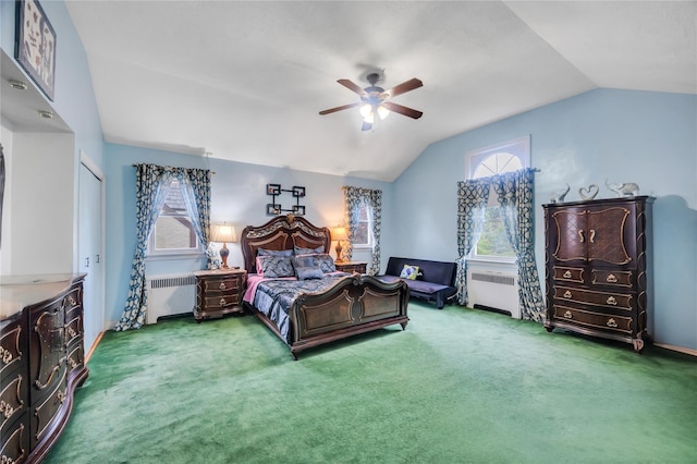 bedroom featuring radiator, vaulted ceiling, carpet floors, and a ceiling fan