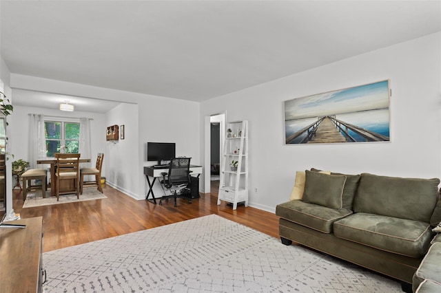 121 N Broadway Unit 22F, White Plains, NY 10603 - living room featuring wood finished floors, baseboards, and a desk