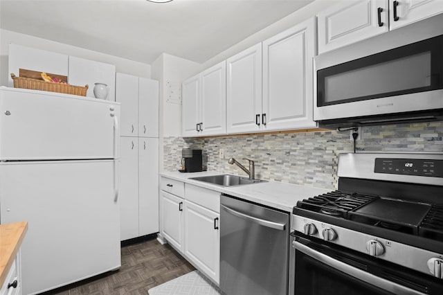 121 N Broadway Unit 22F, White Plains, NY 10603 - kitchen with appliances with stainless steel finishes, a sink, light countertops, white cabinets, and backsplash