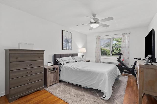 121 N Broadway Unit 22F, White Plains, NY 10603 - bedroom featuring light wood-style flooring, ceiling fan, and radiator