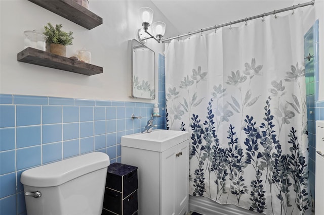 121 N Broadway Unit 22F, White Plains, NY 10603 - bathroom featuring toilet, vanity, tile walls, a shower with curtain, and wainscoting