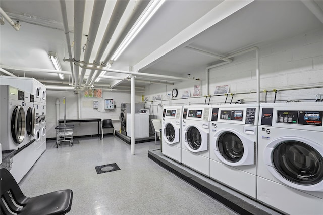 121 N Broadway Unit 22F, White Plains, NY 10603 - community laundry featuring washer and dryer, stacked washer and clothes dryer, concrete block wall, and a garage