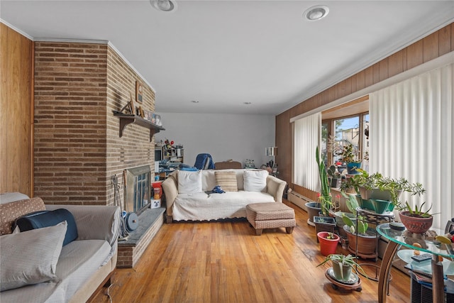 626 Union Ave, New Windsor, NY 12553 - living area with hardwood / wood-style flooring, a brick fireplace, and wood walls