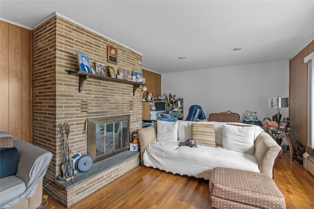626 Union Ave, New Windsor, NY 12553 - living area with wood walls, wood finished floors, and a brick fireplace