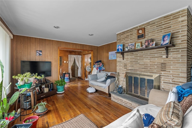 626 Union Ave, New Windsor, NY 12553 - living area with wood walls, hardwood / wood-style floors, a fireplace, and crown molding