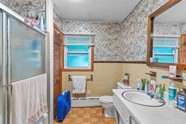 626 Union Ave, New Windsor, NY 12553 - full bath with wallpapered walls, baseboard heating, wainscoting, tile walls, and toilet