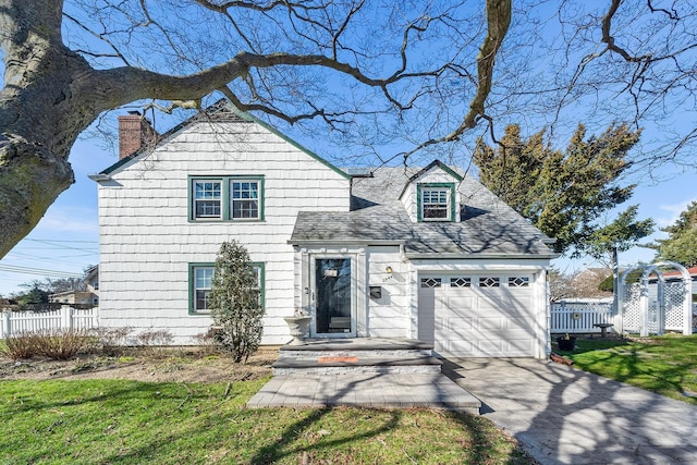 2944 Tulip Ave, Baldwin, NY 11510 - traditional home featuring a garage, a chimney, concrete driveway, and roof with shingles