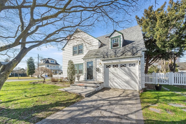 2944 Tulip Ave, Baldwin, NY 11510 - view of front facade featuring driveway, a garage, and roof with shingles
