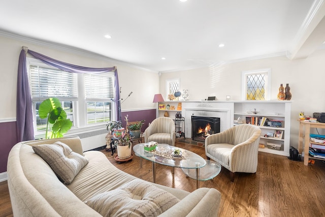 2944 Tulip Ave, Baldwin, NY 11510 - living area with ornamental molding, a brick fireplace, wood finished floors, and recessed lighting