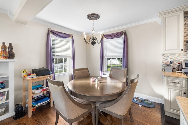 2944 Tulip Ave, Baldwin, NY 11510 - dining room with ornamental molding, dark wood-style floors, a chandelier, and baseboards
