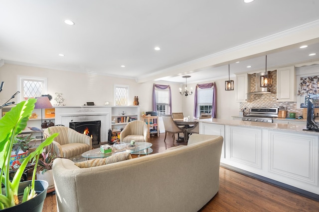 2944 Tulip Ave, Baldwin, NY 11510 - living area featuring crown molding, recessed lighting, a fireplace, dark wood-style floors, and a chandelier