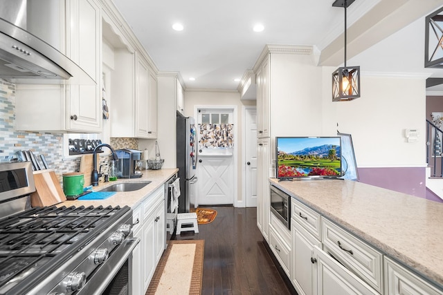 2944 Tulip Ave, Baldwin, NY 11510 - kitchen with under cabinet range hood, a sink, stainless steel appliances, crown molding, and white cabinetry