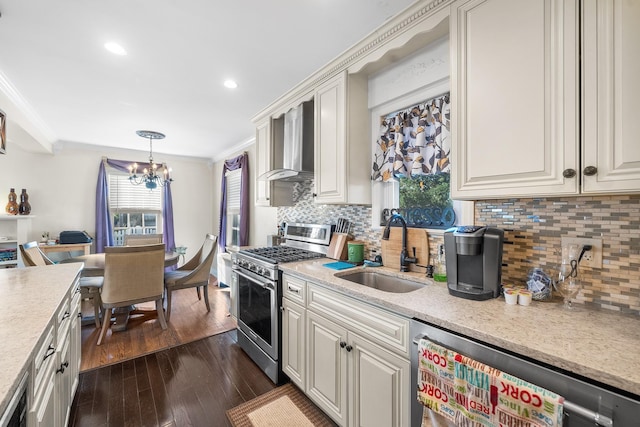 2944 Tulip Ave, Baldwin, NY 11510 - kitchen featuring gas range, wall chimney range hood, a sink, a chandelier, and ornamental molding