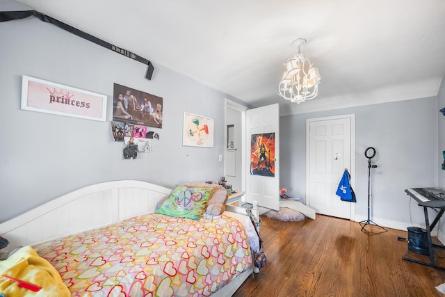 2944 Tulip Ave, Baldwin, NY 11510 - bedroom with a chandelier, wood finished floors, and baseboards