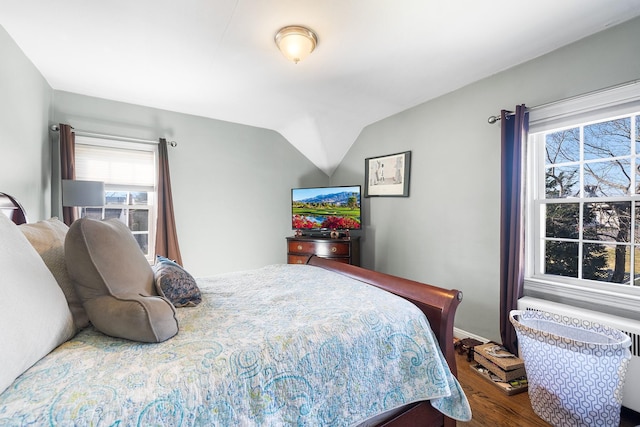 2944 Tulip Ave, Baldwin, NY 11510 - bedroom with wood finished floors, multiple windows, baseboards, and lofted ceiling