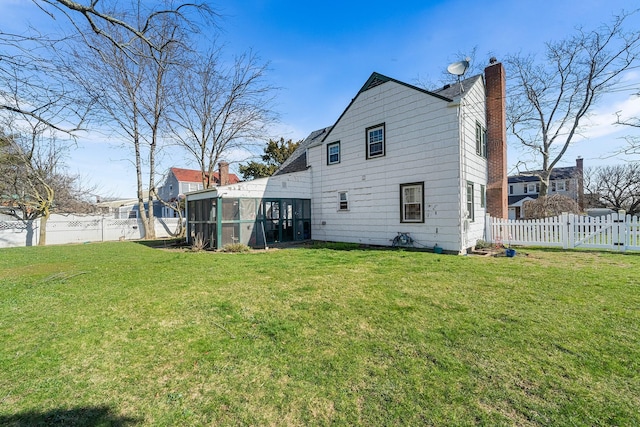 2944 Tulip Ave, Baldwin, NY 11510 - rear view of house with a sunroom and a chimney