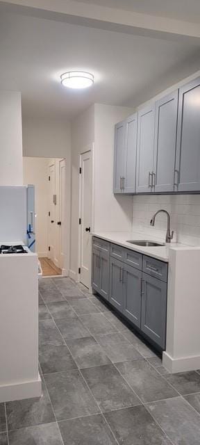 2925 Matthews Ave Unit 2H, Bronx, NY 10467 - kitchen with gray cabinetry, a sink, light countertops, and freestanding refrigerator