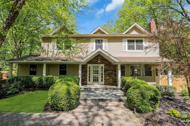 7 Mcculloch Dr, Dix Hills, NY 11746 - view of front facade featuring a chimney, stone siding, a shingled roof, and covered porch