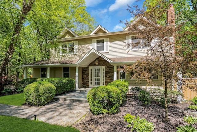 7 Mcculloch Dr, Dix Hills, NY 11746 - view of front of property with a chimney, stone siding, and a porch