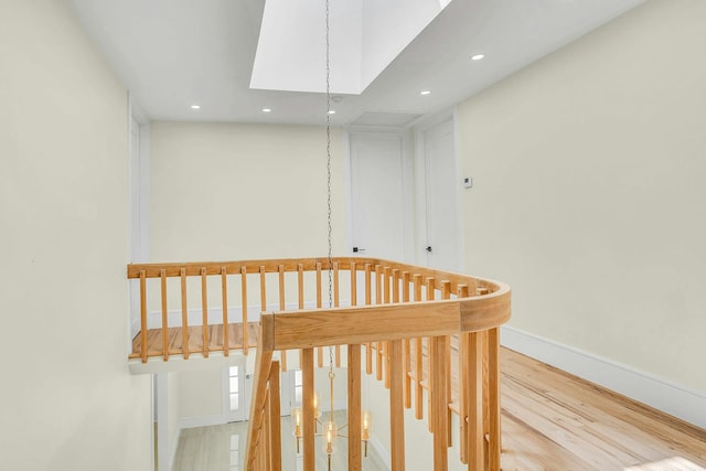 7 Mcculloch Dr, Dix Hills, NY 11746 - stairs featuring recessed lighting, a skylight, wood finished floors, and baseboards