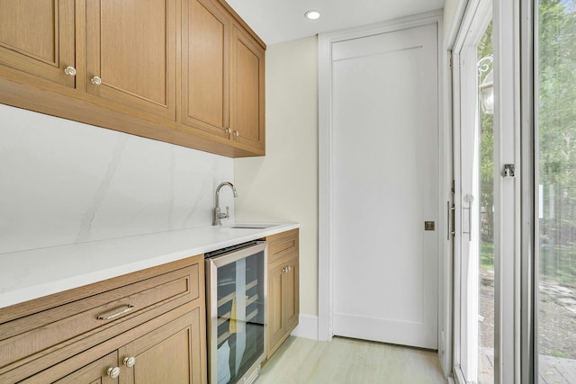 7 Mcculloch Dr, Dix Hills, NY 11746 - indoor wet bar featuring beverage cooler, light wood-style flooring, and recessed lighting