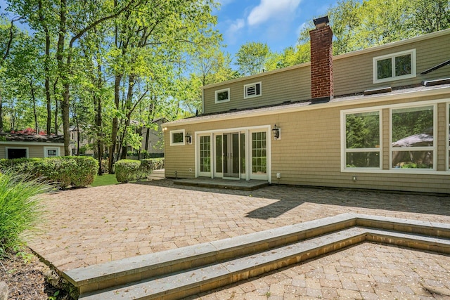 7 Mcculloch Dr, Dix Hills, NY 11746 - back of house with french doors, a patio, and a chimney