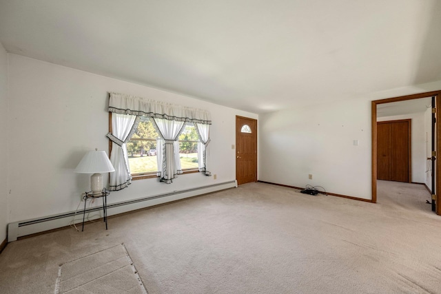 entrance foyer featuring a baseboard heating unit, light carpet, and baseboards